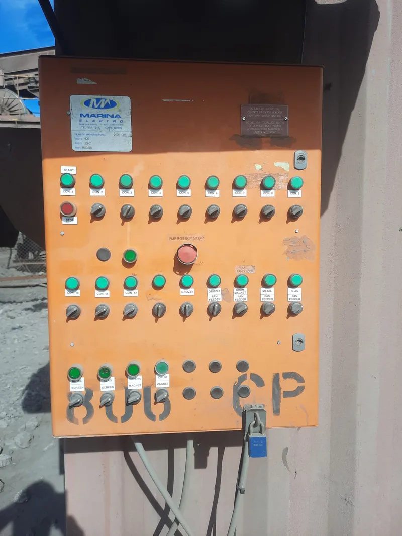 Orange control panel with labelled switches and indicator lights in the metal recovery plant photo set.